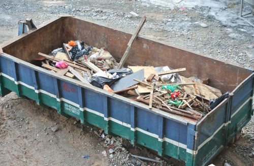 Rubbish removal team at work with safety gear and protected handling procedures